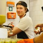 Mann befüllt Gläser mit Brotaufstrich